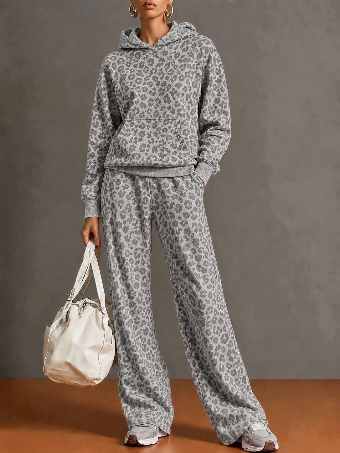 Full-length view of the gray leopard print hoodie and wide-leg pants set on a model