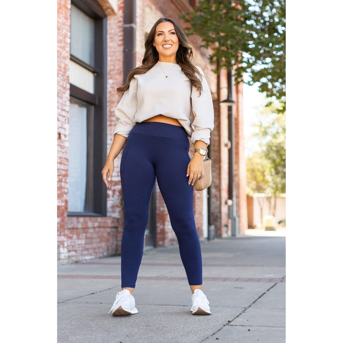 Nyla navy full-length leggings with pockets worn with a casual top, showcasing a stylish outdoor ensemble.