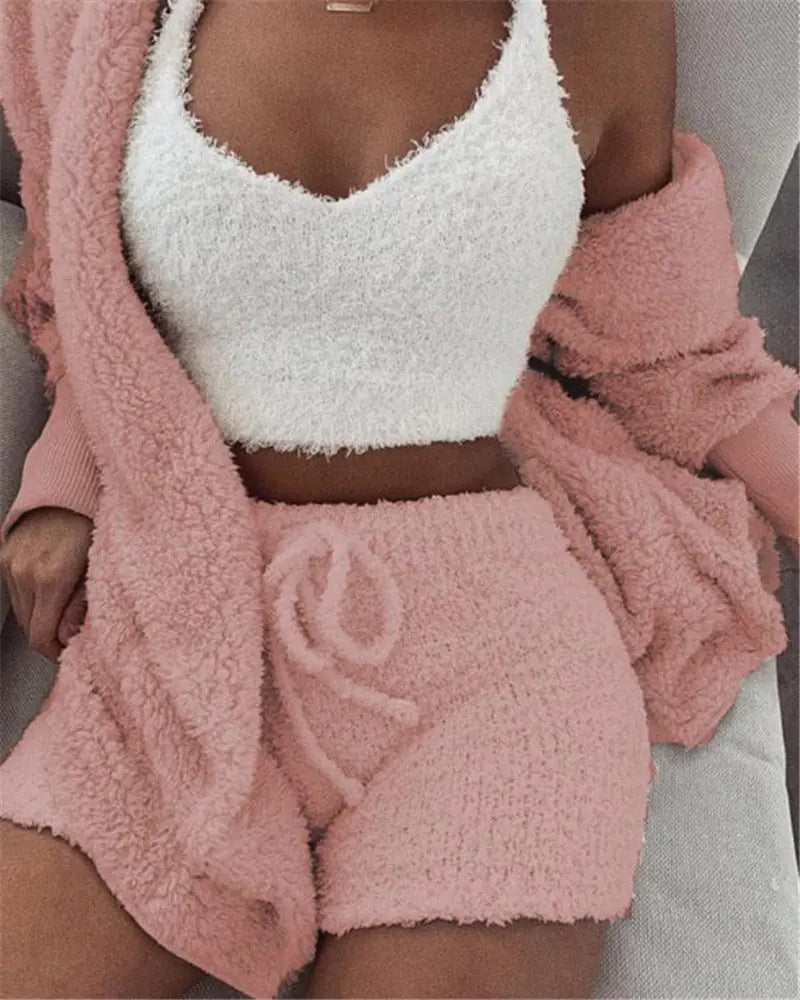 Model wearing a white fuzzy cami with pink drawstring shorts and a matching pink cardigan