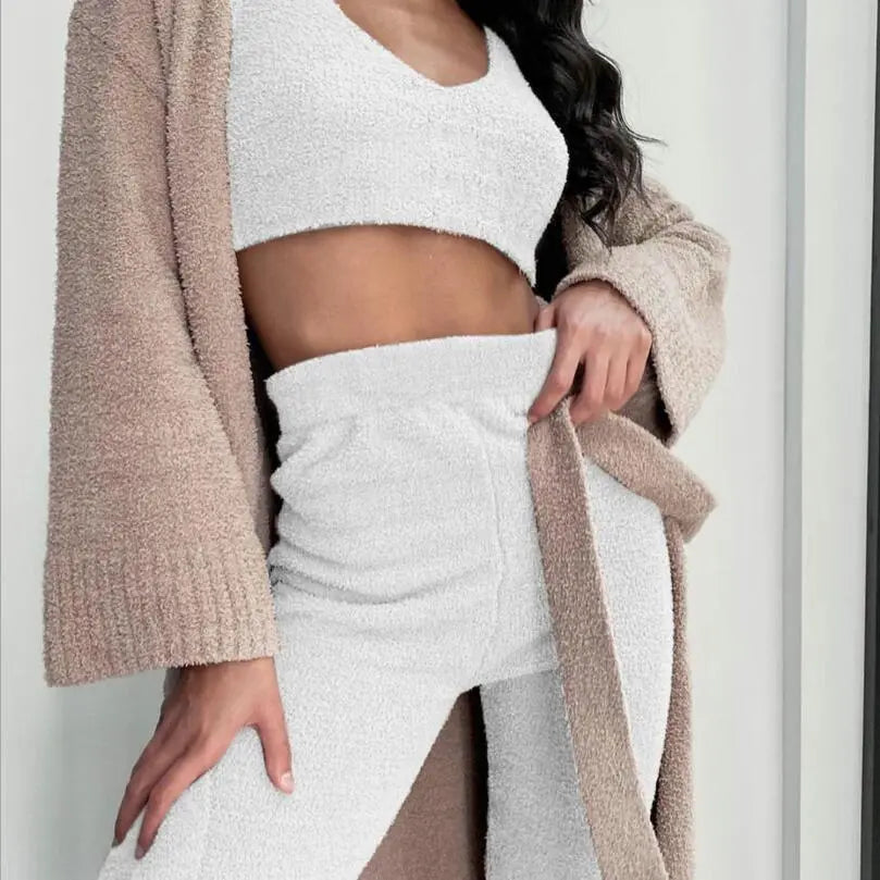 Model wearing a white fuzzy cami top and matching pants with a tan open cardigan