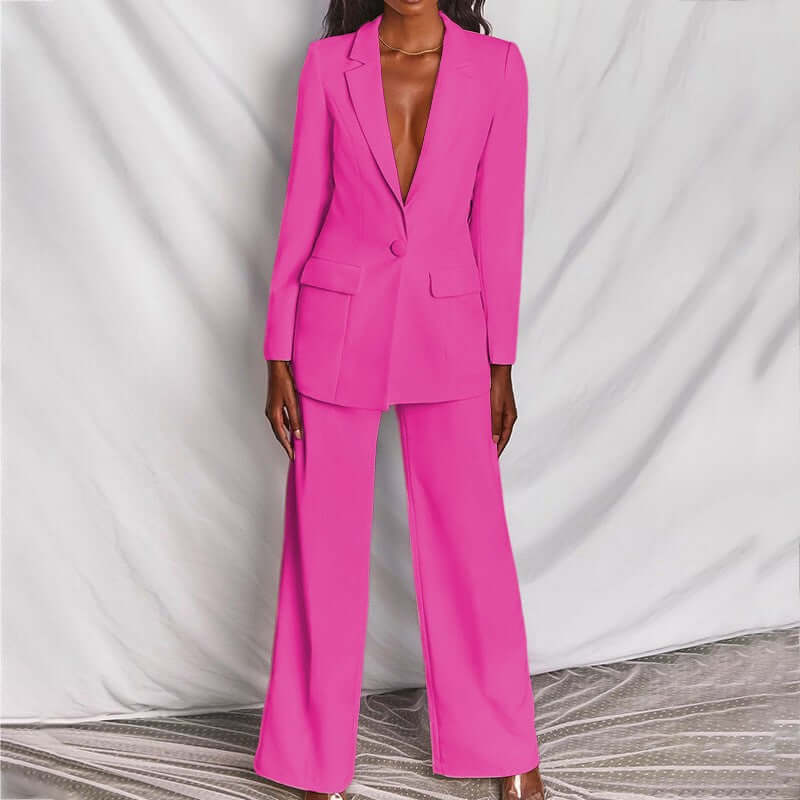 women's professional blazer trousers suit set in vibrant pink, featuring a tailored long-sleeve blazer and wide-leg trousers.