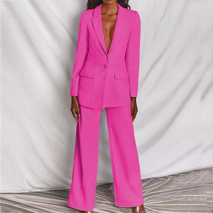 women's professional blazer trousers suit set in vibrant pink, featuring a tailored long-sleeve blazer and wide-leg trousers.