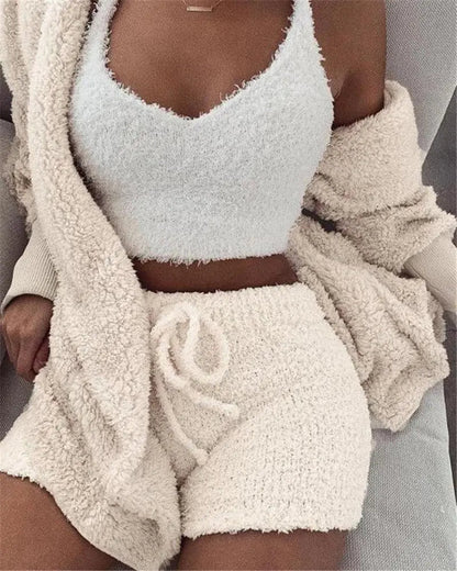 Model wearing a white fuzzy cami with cream drawstring shorts and a matching cardigan