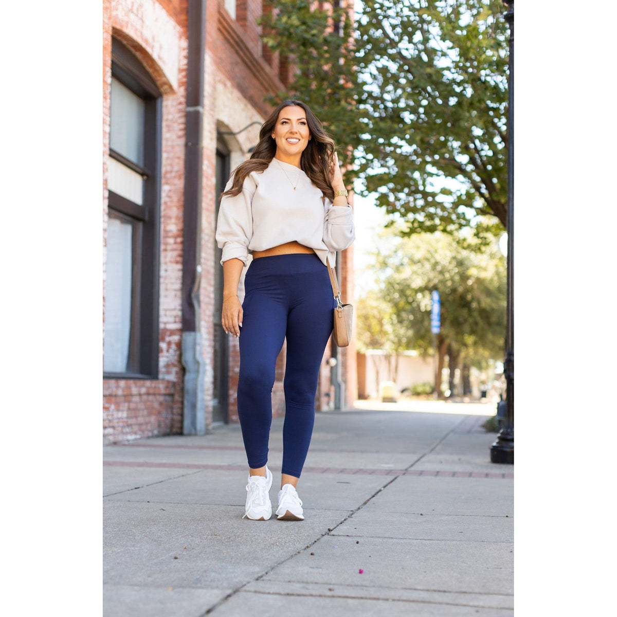 Nyla navy full-length leggings with pockets, styled for comfort and casual outings, paired with a cropped sweater.