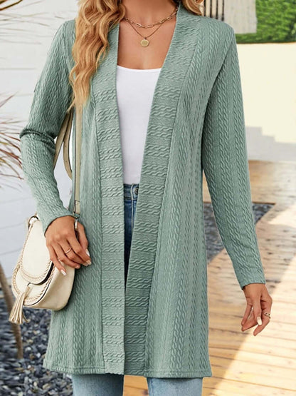 Woman wearing a light green women's knit cardigan with a relaxed fit, styled for transitional seasons.