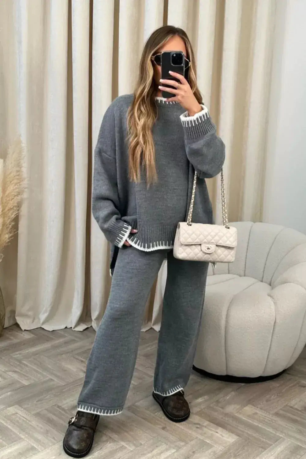 Contrast Trim Knit Set featuring a round neck top and pants, styled with a handbag in a cozy indoor setting.