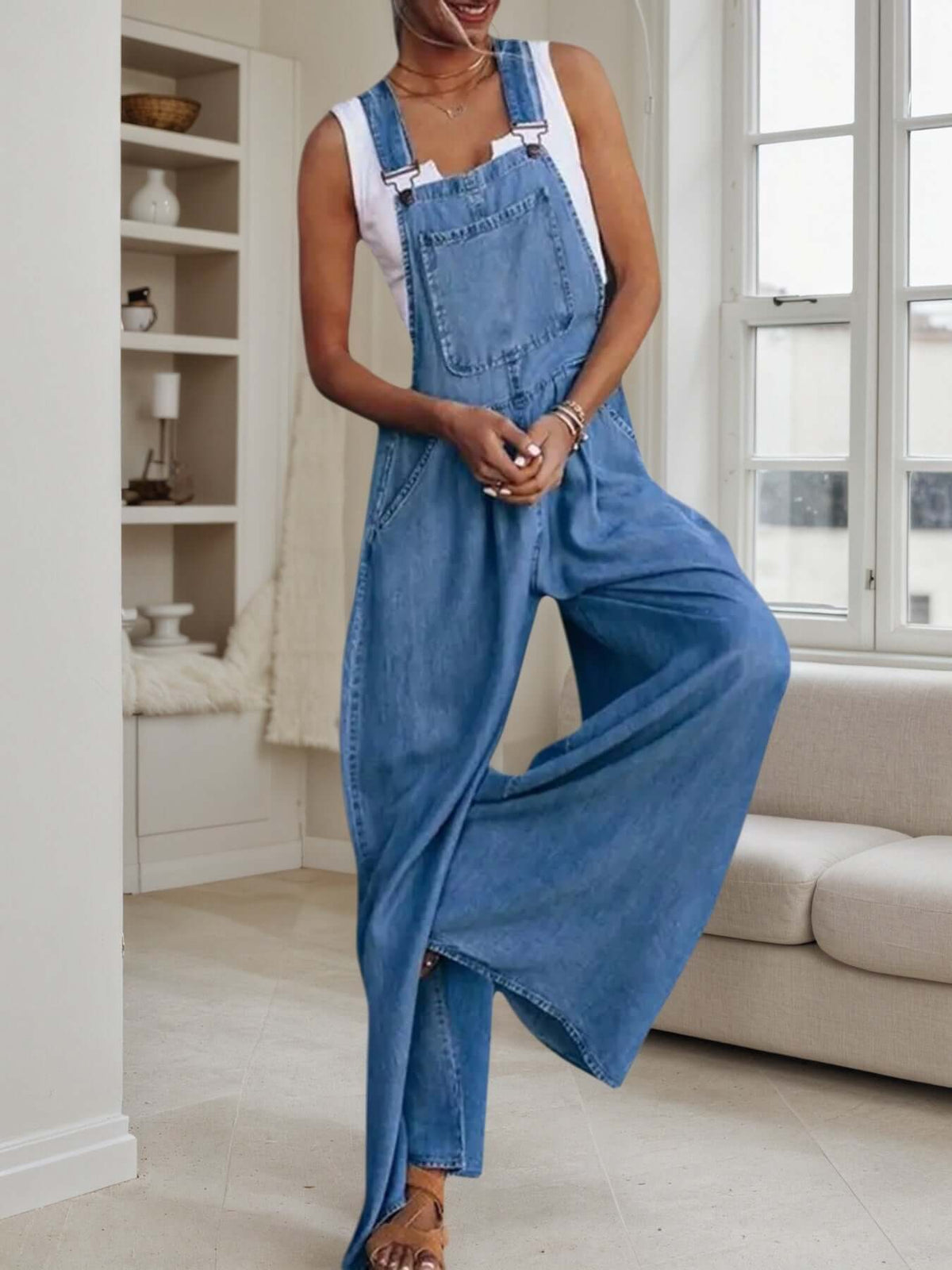 women's wide-leg denim overalls worn by a model in a stylish indoor setting.