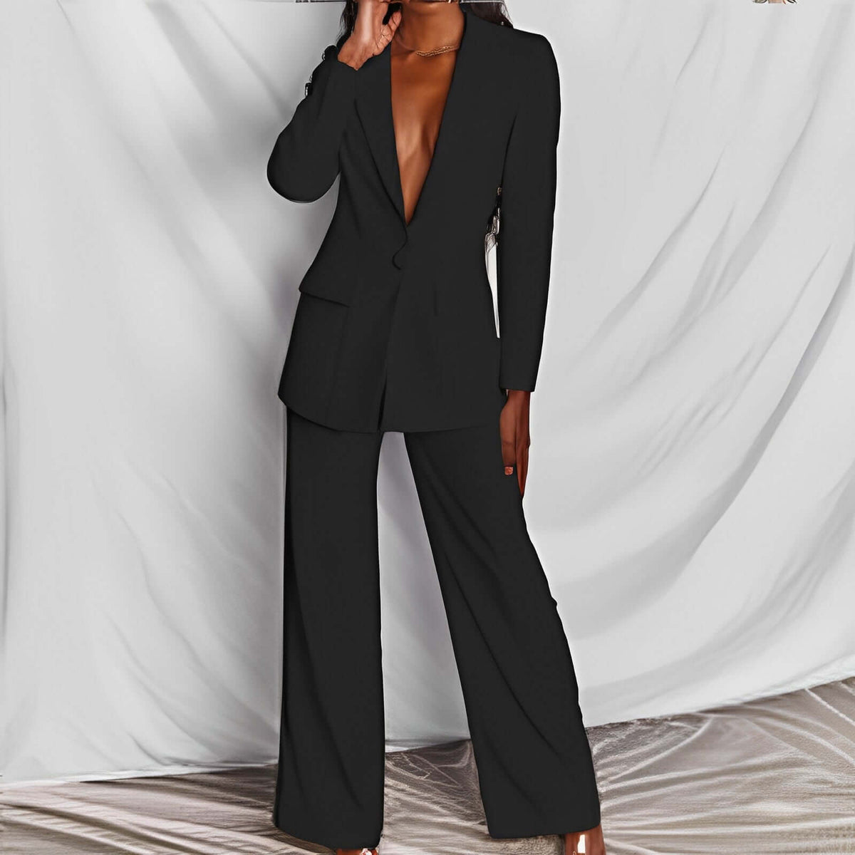 Women's professional blazer trousers suit set in black, showcasing a tailored long-sleeve blazer and full-length trousers.