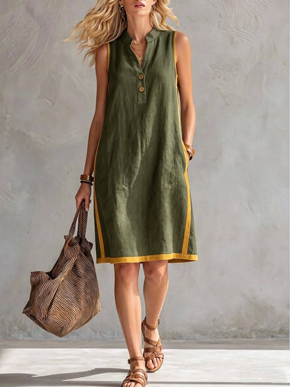 womens v-neck button-front midi dress in olive green with buttons and trim, paired with a stylish bag.