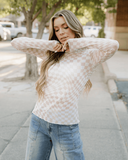 Model wearing a khaki sheer checkered top, showcasing its stylish design and lightweight fabric.