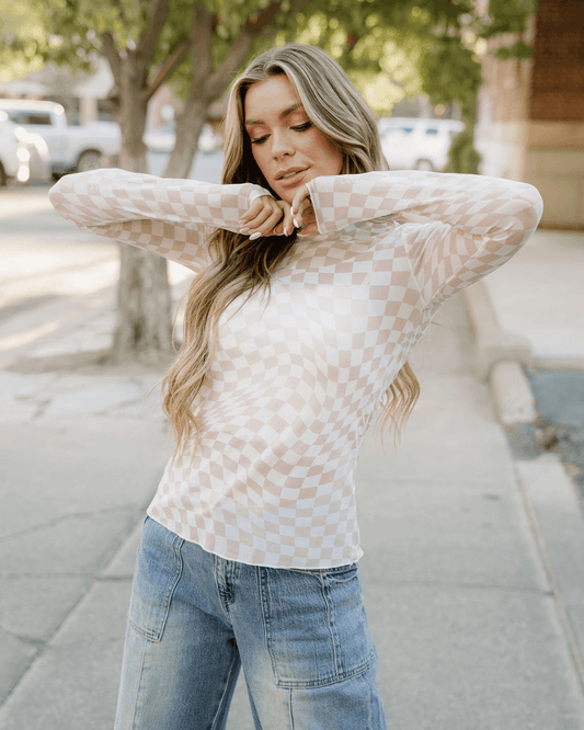 Model wearing a khaki sheer checkered top, showcasing its stylish design and lightweight fabric.