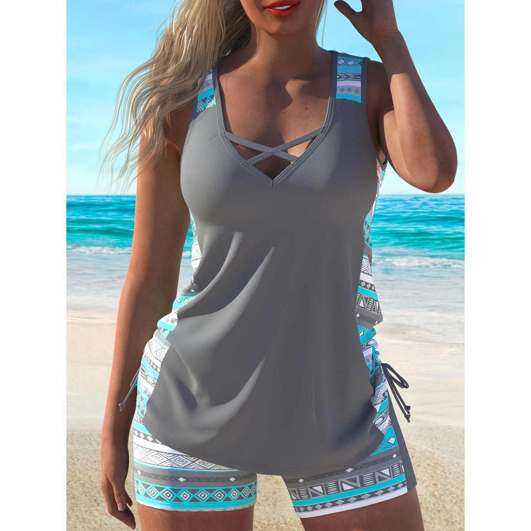 Plus size Aztec print tankini set featuring a gray tank top with cross-strap detail and stylish patterned shorts.