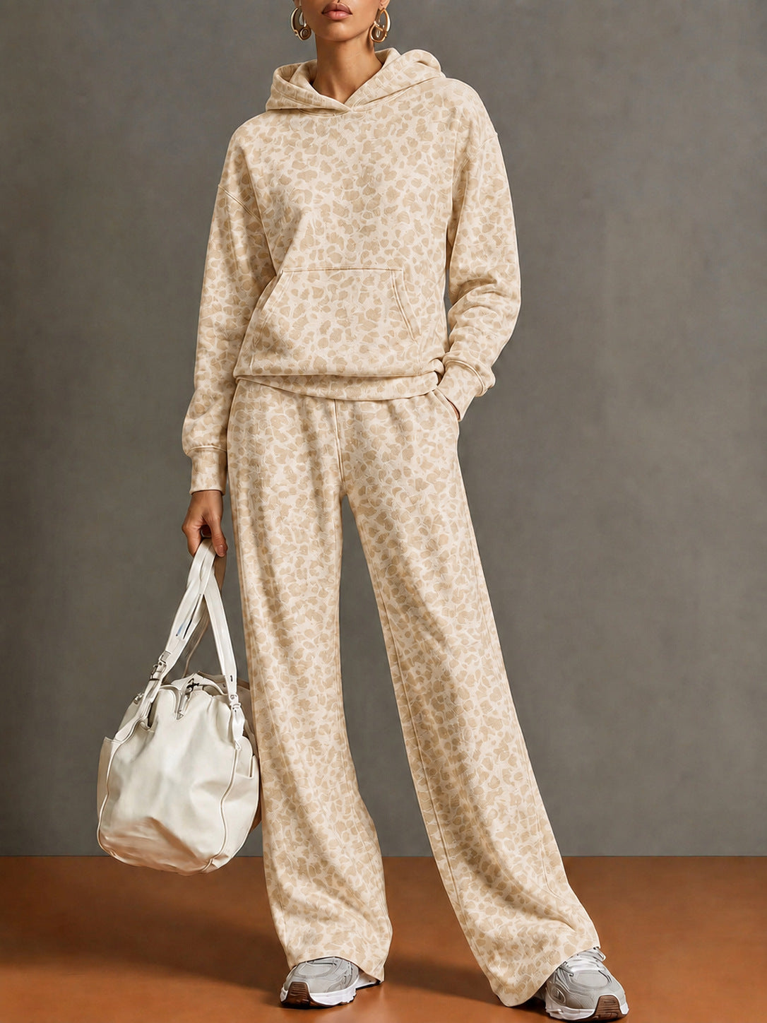 Full-length view of the champagne leopard print hoodie and wide-leg pants set on a model
