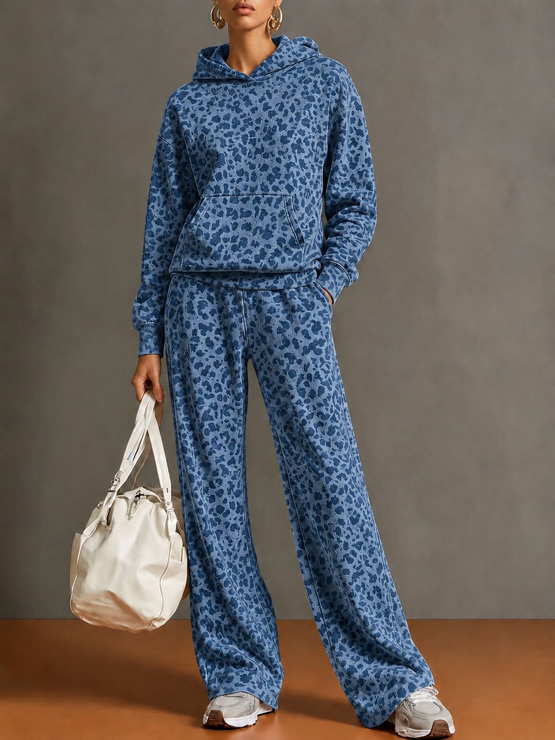 Full-length view of the blue leopard print hoodie and wide-leg pants set on a model