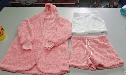 Flat lay of the pink hooded cardigan, white cami top, and pink drawstring shorts
