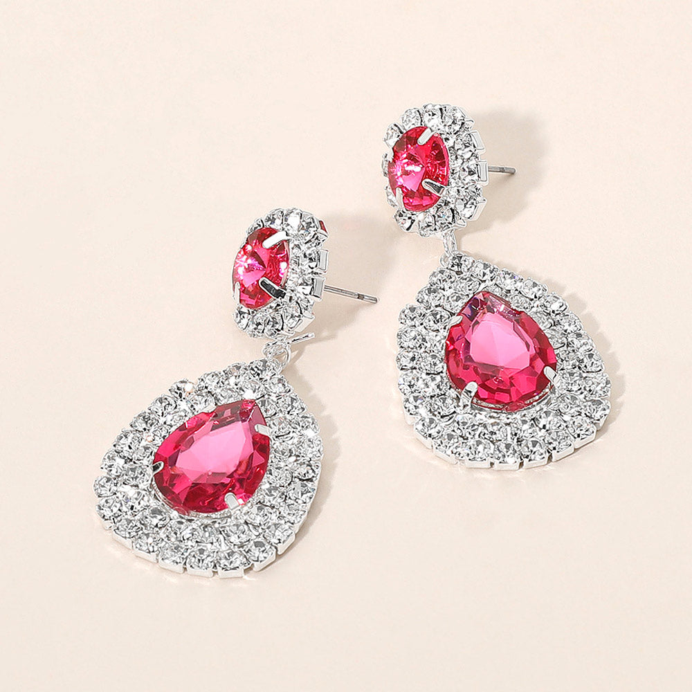 Stunning glass crystal teardrop earrings with pink gemstones and a sparkling silver setting.