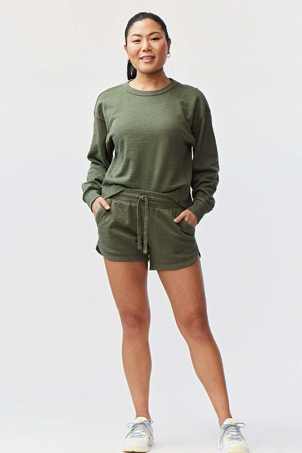Model wearing Freasy Garment-Washed Cotton Shorts paired with a cozy sweatshirt in olive green.