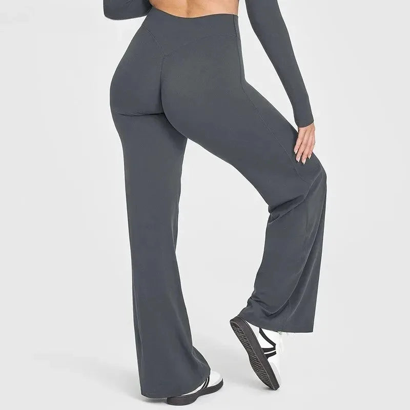 Back view of a woman wearing high-waisted yoga running pants in gray, showcasing comfort and style.