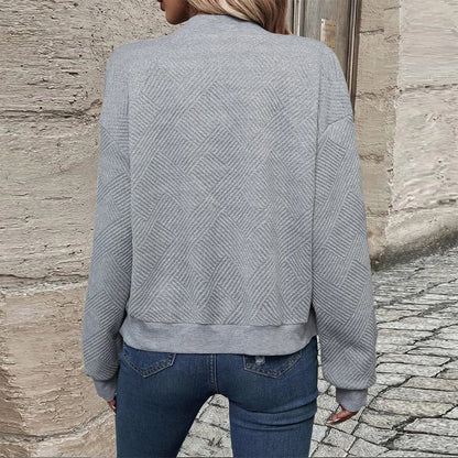 Back view of the gray zip-up stand-collar jacket on a model