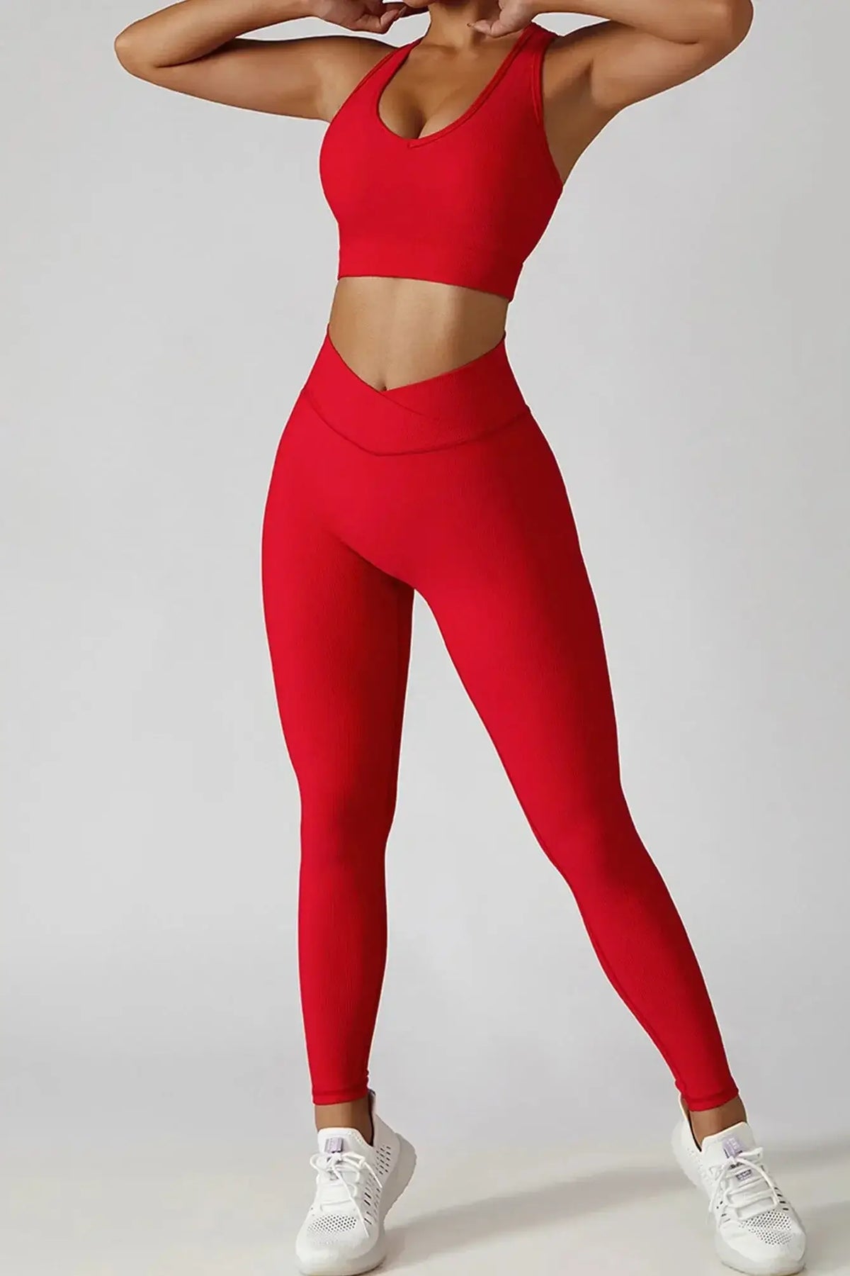 Model wearing a 3-piece seamless yoga set consisting of a red sports bra and leggings, showcasing style and comfort.