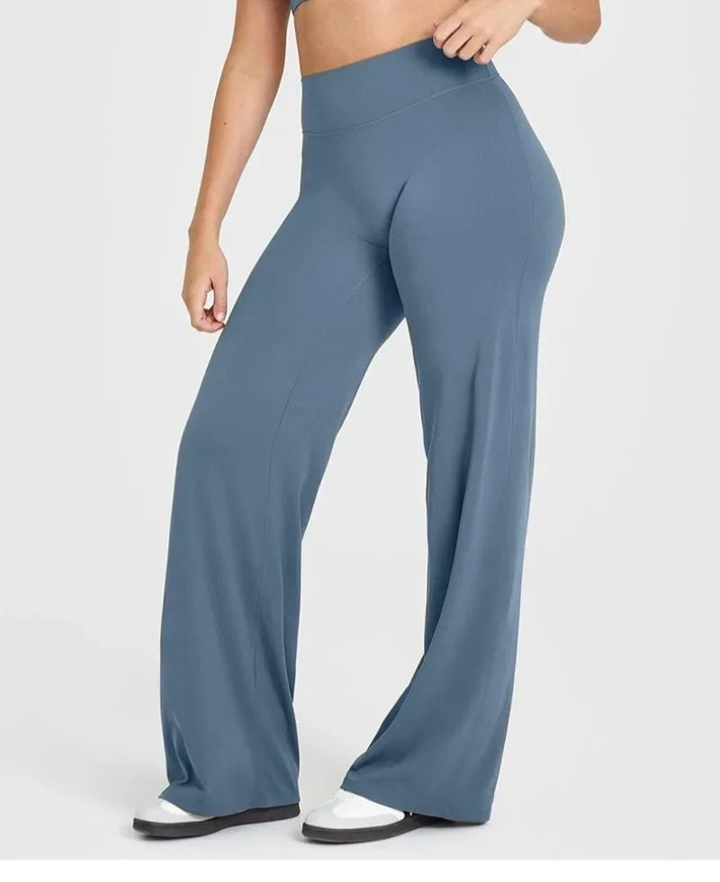 Women wearing high-waisted yoga running pants in a stylish blue color, perfect for yoga or daily activities.