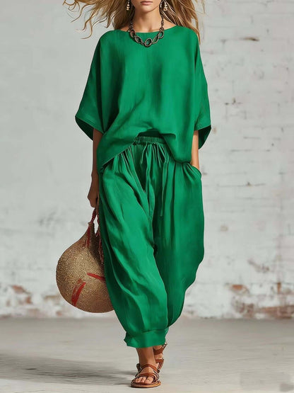 Women's casual t-shirt and ankle pants set in vibrant green, featuring a relaxed fit top and baggy pants.