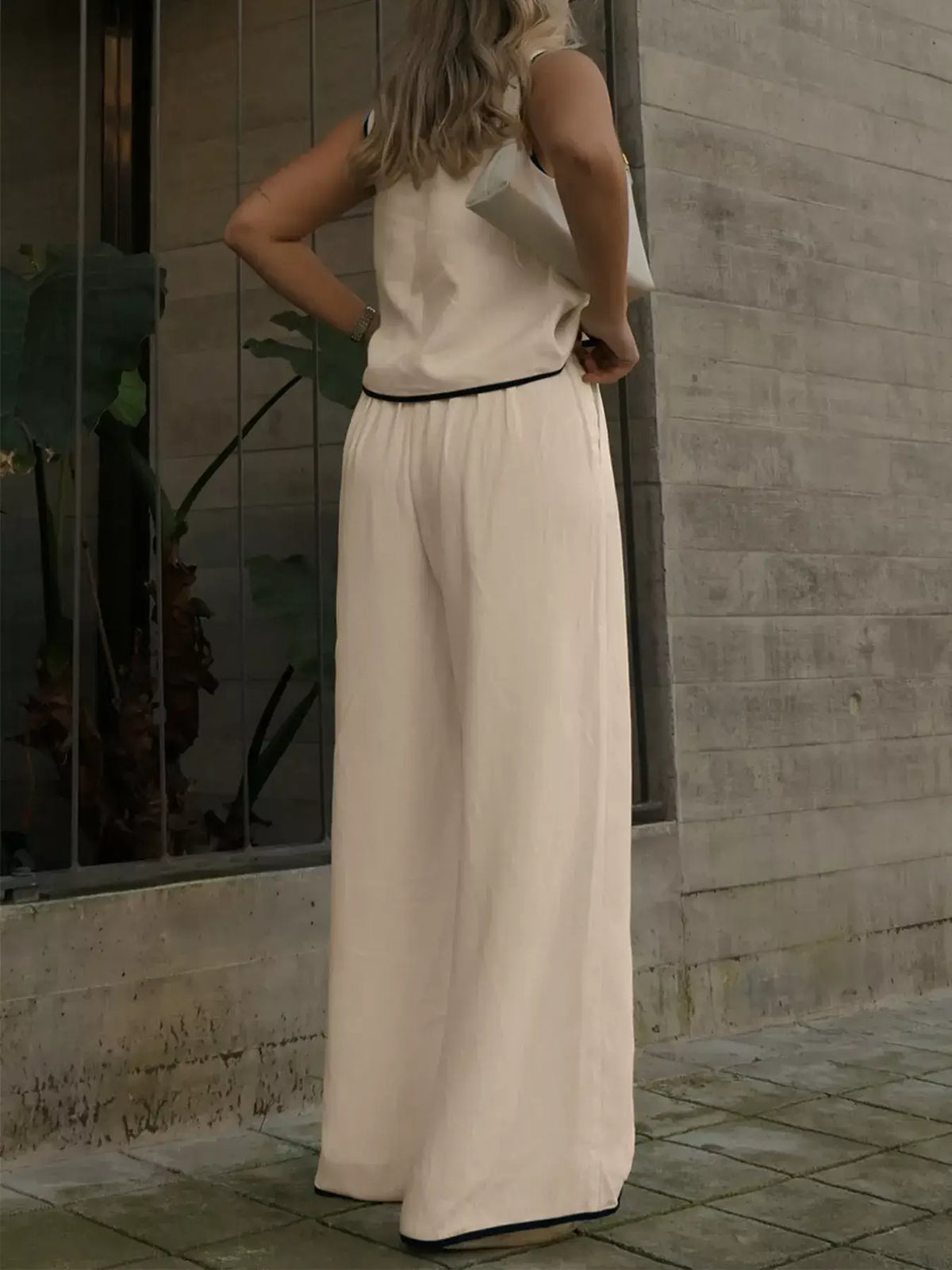 Woman wearing Contrast Trim Top and Wide Leg Pants Set, showcasing the stylish back view and relaxed fit.