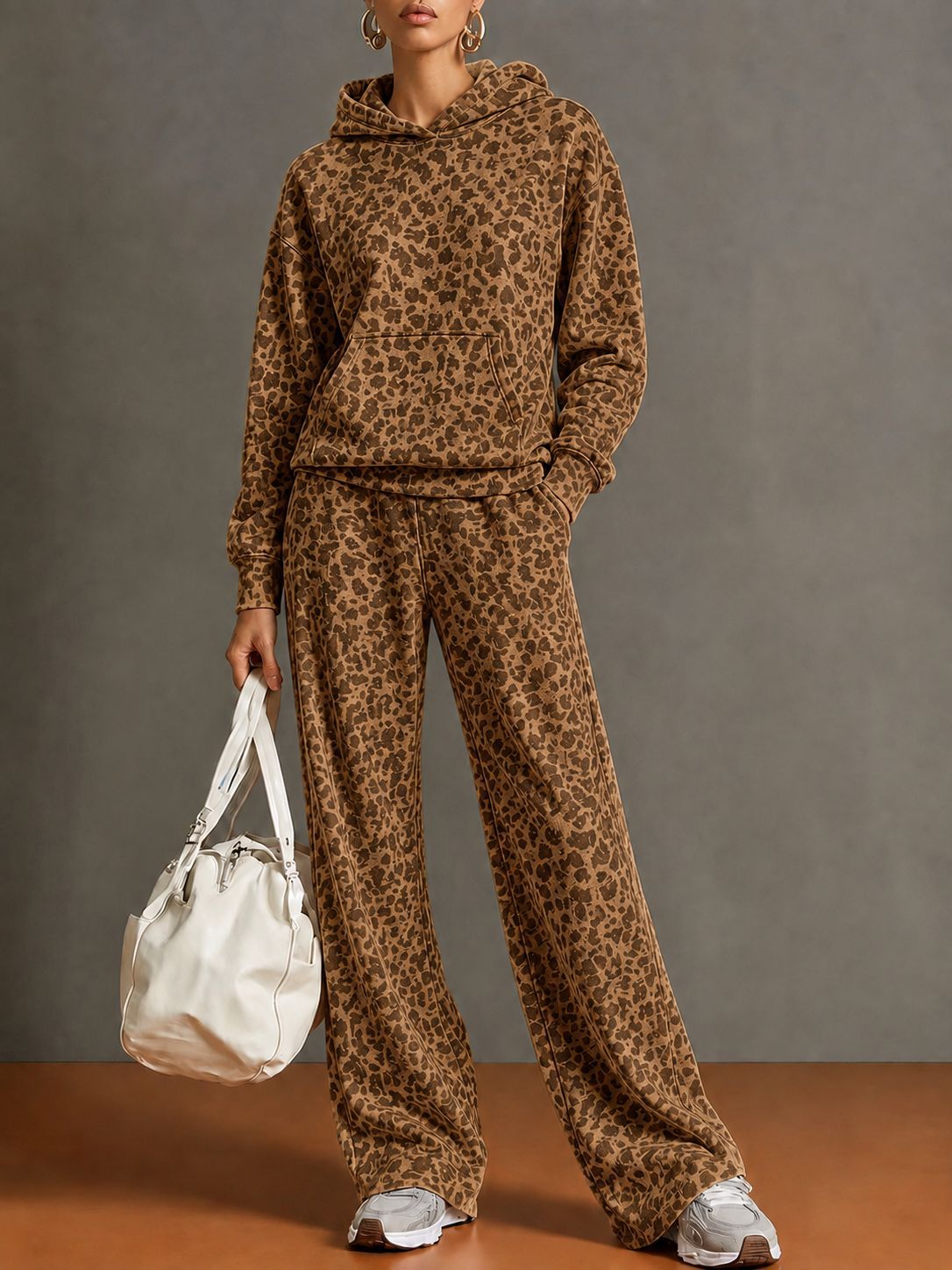 Model wearing an amber brown leopard print hoodie and wide-leg pants set