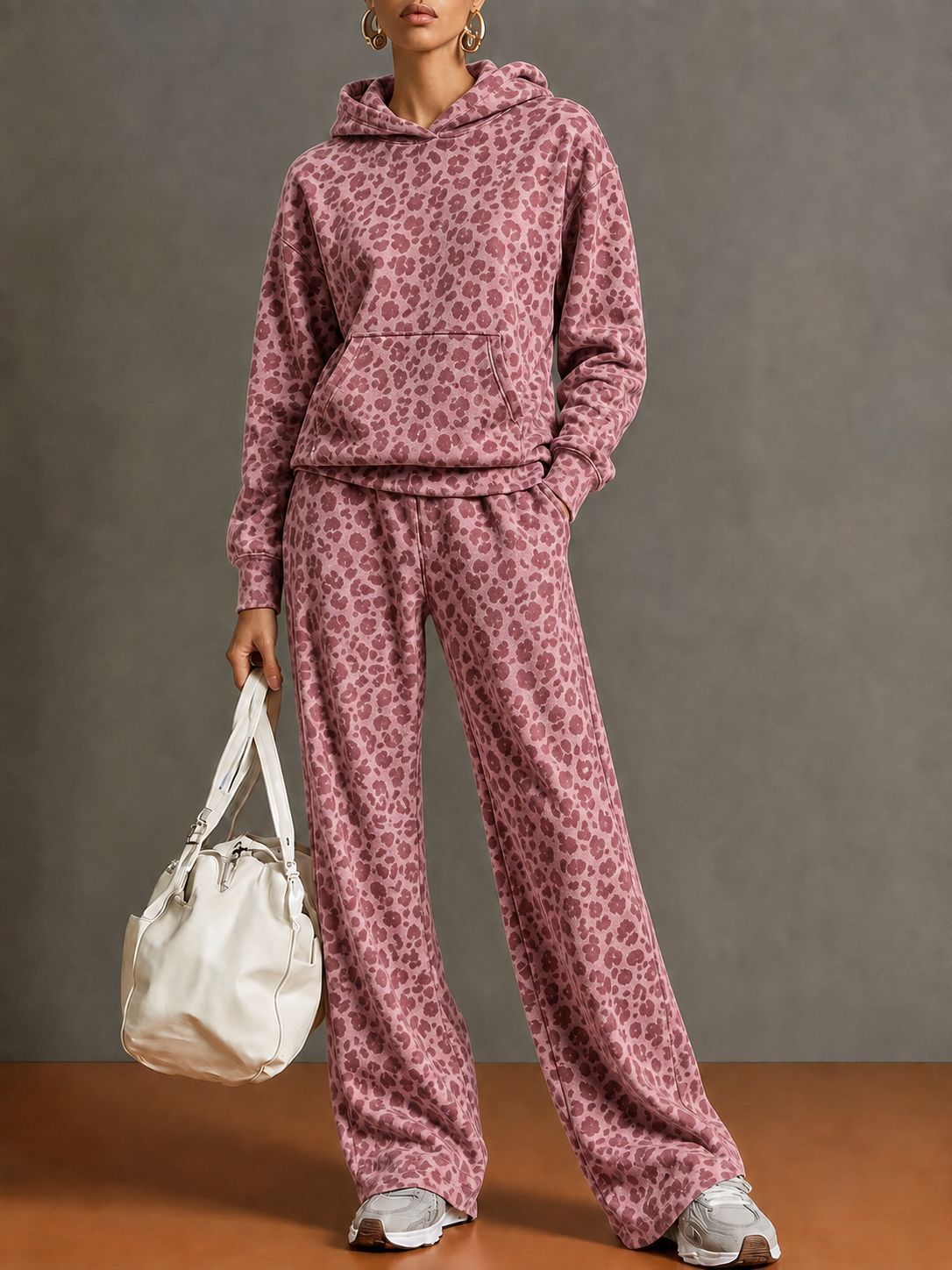 Model wearing a rose pink leopard print hoodie and wide-leg pants set