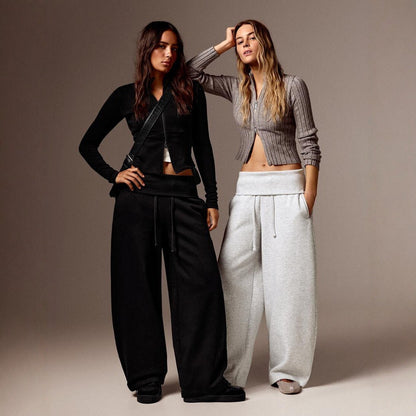 Two models wearing the high-waist wide-leg pants in black and gray