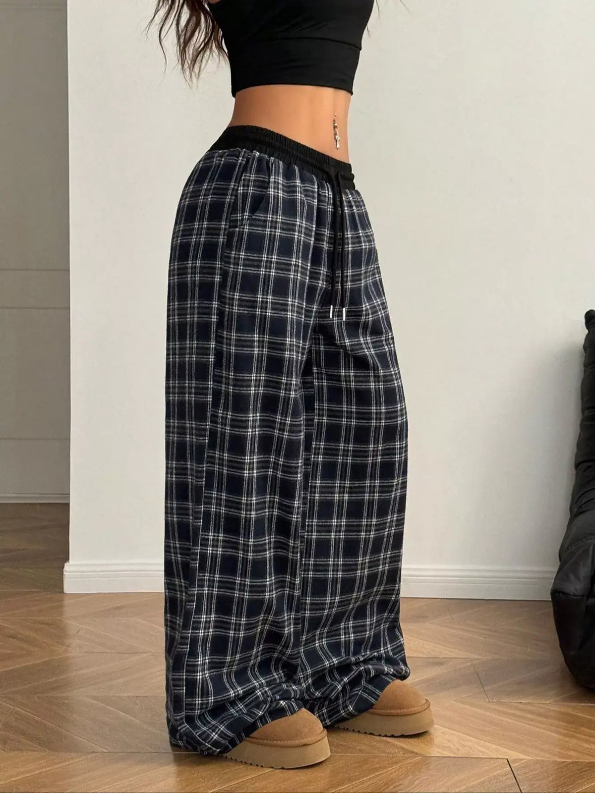 Women's relaxed plaid pants in black and white plaid pattern, featuring a comfortable, stylish fit.