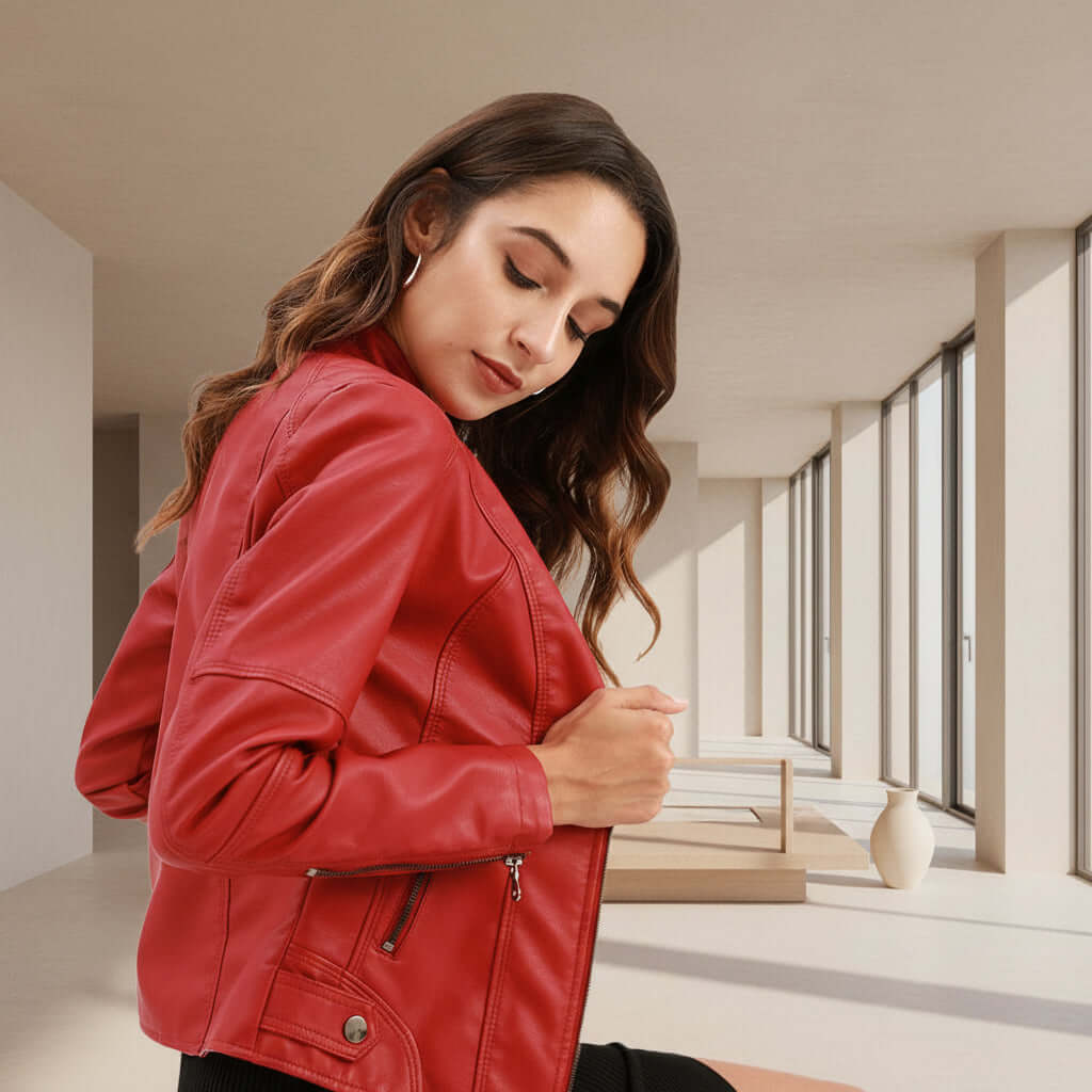 Woman wearing a womens classic leather jacket in a modern interior setting.