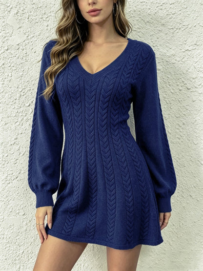 Model wearing a navy blue cable-knit V-neck pullover dress