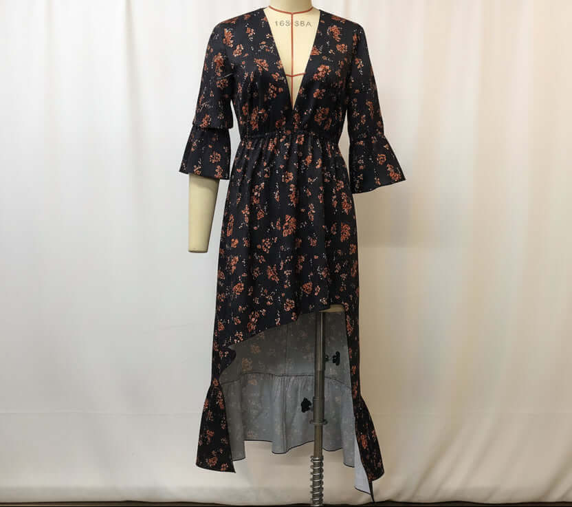 Women's floral denim patchwork midi dress featuring a plunging neckline and flared sleeves.