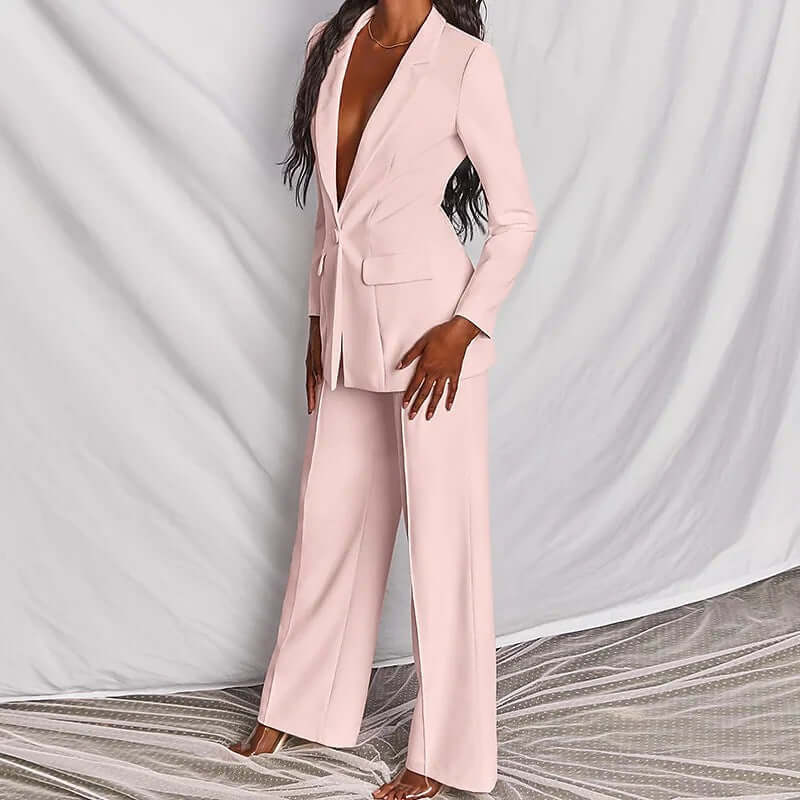 Women's professional blazer trousers suit set in pastel pink, featuring a tailored long-sleeve blazer and wide-leg trousers.