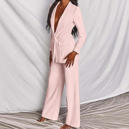 Women's professional blazer trousers suit set in pastel pink, featuring a tailored long-sleeve blazer and wide-leg trousers.