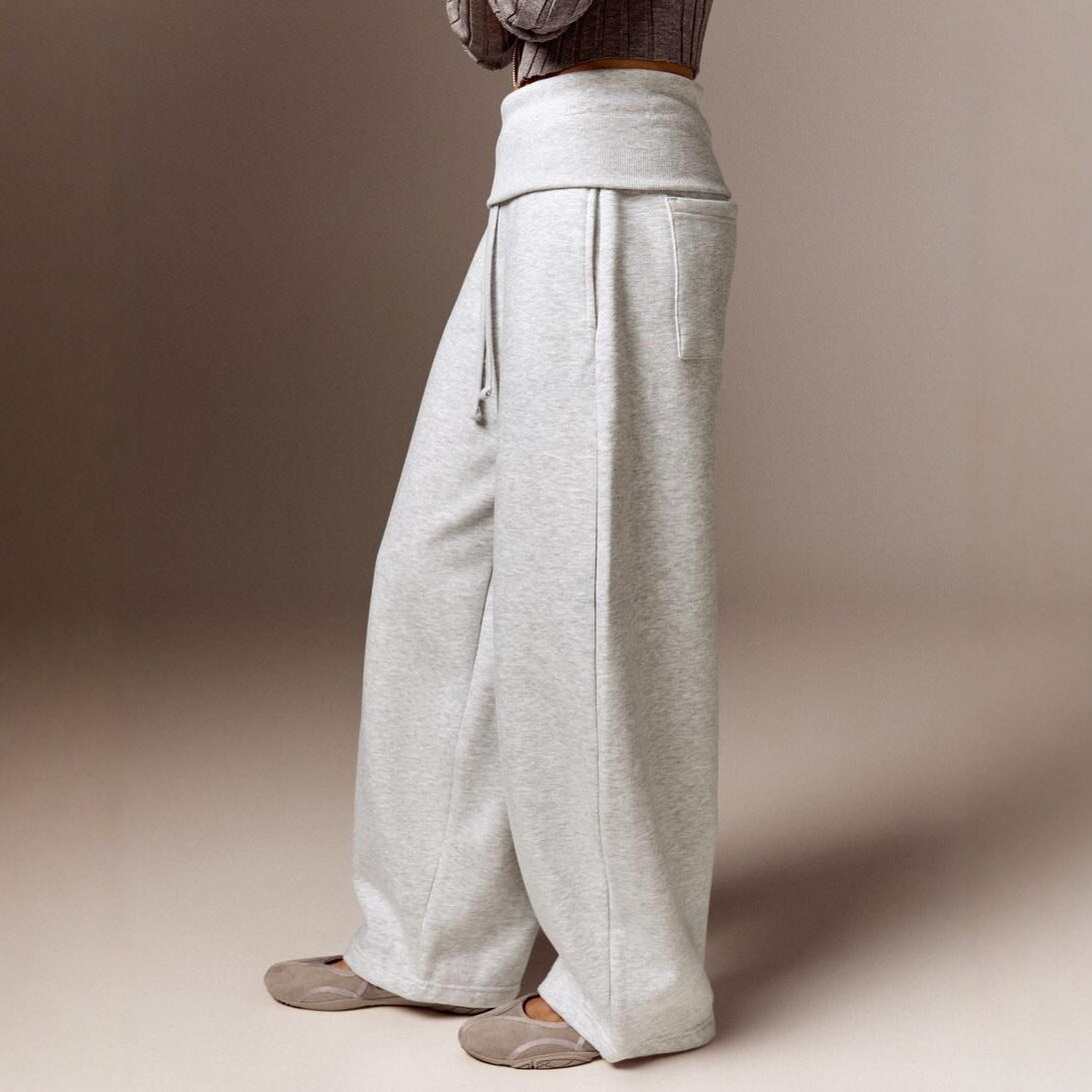 Side view of the gray high-waist wide-leg casual pants on a model