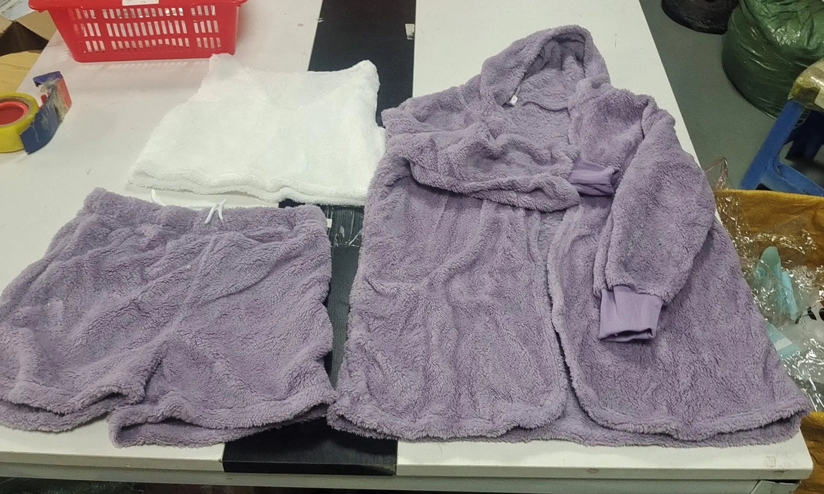 Flat lay of the violet hooded cardigan, white cami top, and violet drawstring shorts