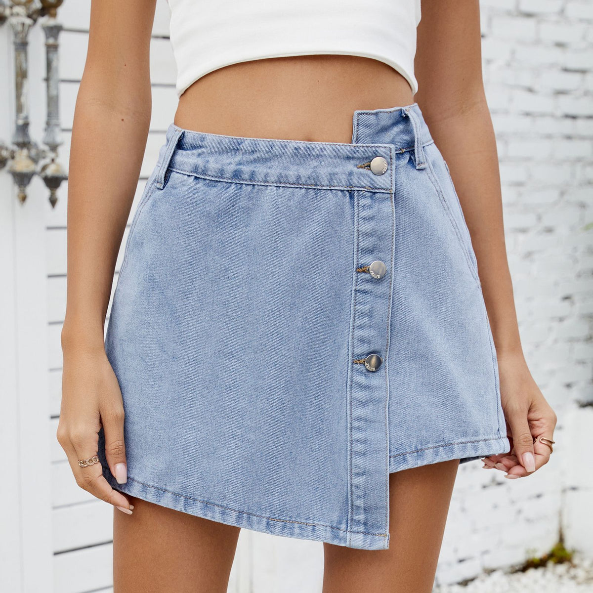 Close-up of women's denim shorts, featuring a button-up design and irregular silhouette, perfect for casual outings.